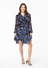Load image into Gallery viewer, Front view. The Alivia Vicki Shirt in Poppy Play Black paired with the Gabi Skirt in Poppy Play Black and black strappy sandals. The shirt is tucked into the waistline of theskirt, creating the effect of a flowy dress with a cinched waist.