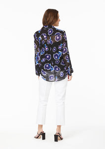 Back view. Poppy Play Black Vicki Shirt. The collar and yoke are lined, complimenting the black camisole,and showing off the sheer area at the upper back. The long sleeves are also sheer and fall to the base of the hand, just past the wrist. There is a bias seam at the elbow, creating a lower blouson sleeve between the elbow and wrist.