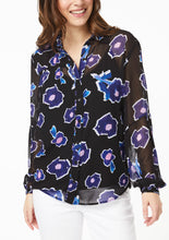 Load image into Gallery viewer, Closeup front view. Vicky Shirt in Poppy Play Black. The top 2 buttons are undone, creating a v-neckline that ends just above the black camisole, collar falling naturally to either side. Lined cuffs at the end of the sleeves have a snug fit around the hand with the blouson sleeve draping down and slightly overlapping the cuff.