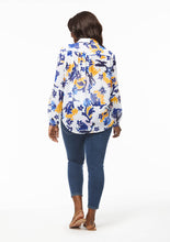 Load image into Gallery viewer, Back view of the Vicki Shirt in Alivia’s Whimsical Floral. The fabric is sheer but almost appears opaque compared to the Poppy Play Black. The shirt hangs naturally around the pleats below the yoke seam. The tail of the shirt hangs down below the back pockets of the blue jeans.
