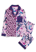 Load image into Gallery viewer, Flat lay. Matching button-down Sofia Pajama Set in Alivia Happy Strokes Pink. The fabric is pale pink with an artistic, modern design of overlapping black, blue, and pink straight and wavy brush strokes. The contrasting fabric of the right shirt panel front is an abstract leopard-style design of black dots squiggles with fuchsiadrop shadows.